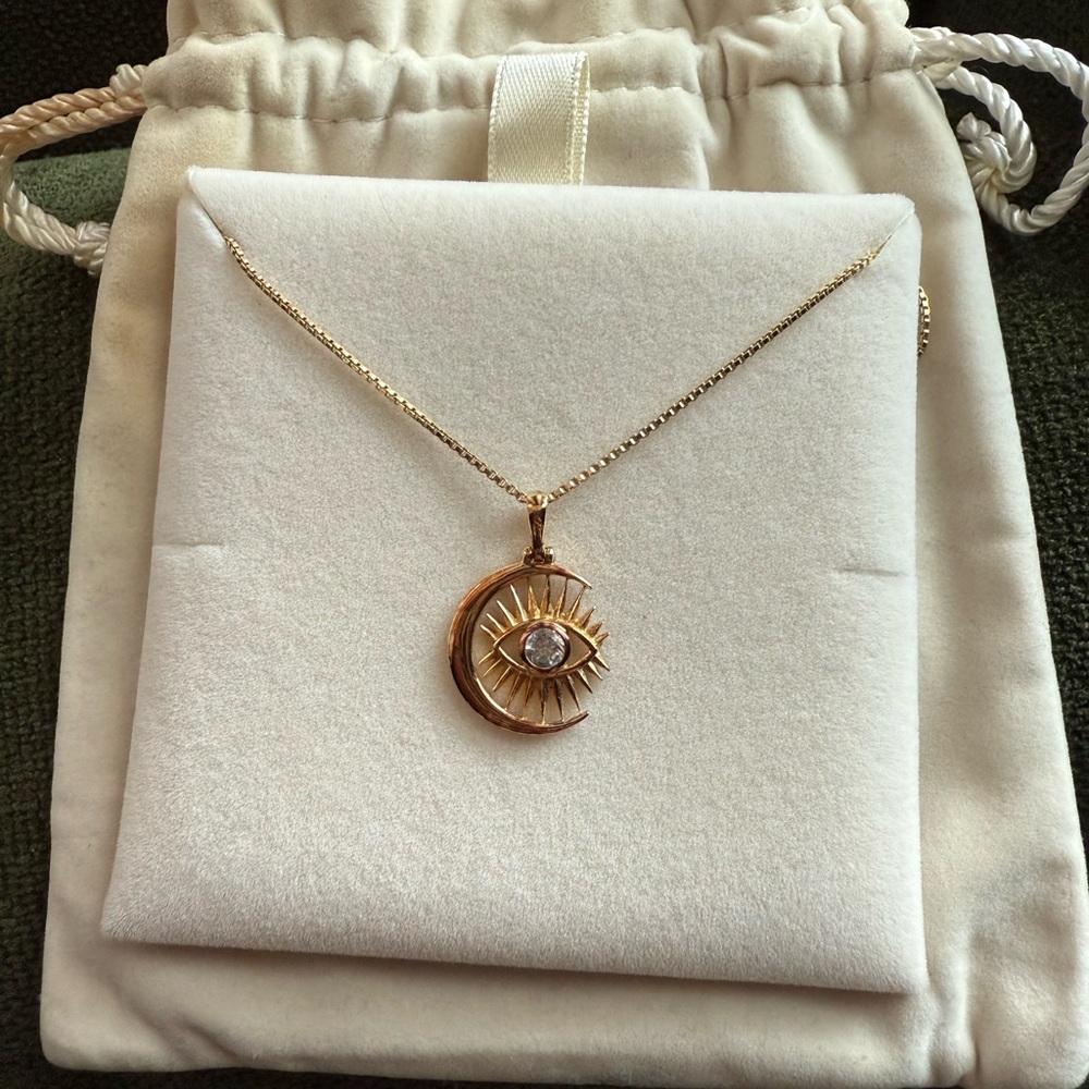 14k yellow gold vermeil with white topaz stone in center. Evil eye and moon